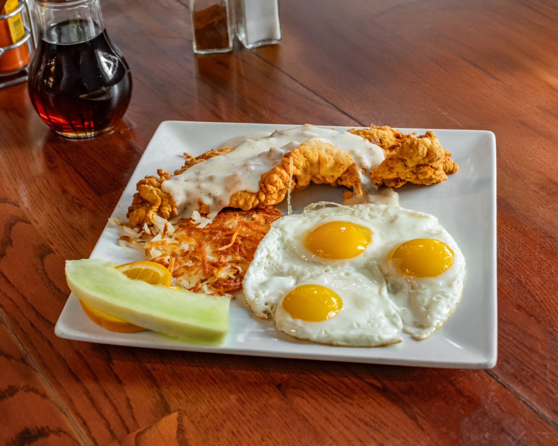 Chicken fried chicken with country gravy, three eggs and crispy hash browns