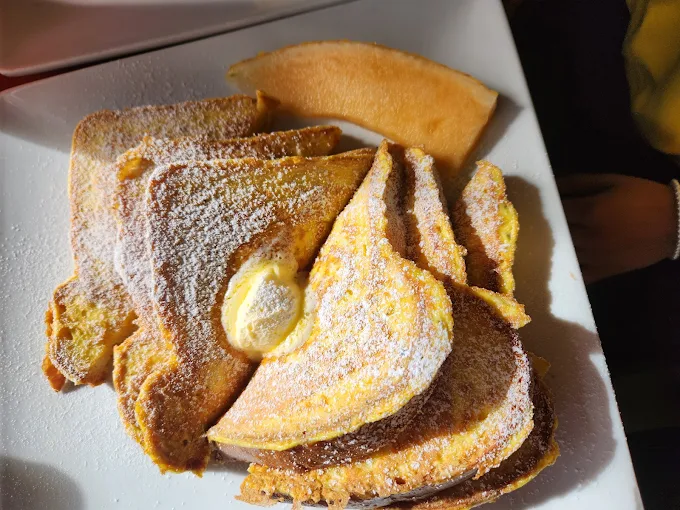 Powdered sugar French toast with butter and melon at Harley's